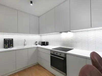 a white kitchen with white cabinets and appliances at FRESH, NEW & READY FOR YOU! RNVTD APT IN KOUKAKI! in Athens