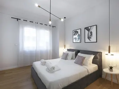 a bedroom with a large bed with towels on it at FRESH, NEW & READY FOR YOU! RNVTD APT IN KOUKAKI! in Athens