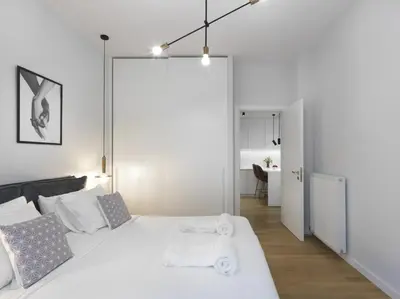 a white bedroom with a bed with towels on it at FRESH, NEW & READY FOR YOU! RNVTD APT IN KOUKAKI! in Athens