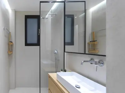 a bathroom with a sink and a glass shower at FRESH, NEW & READY FOR YOU! RNVTD APT IN KOUKAKI! in Athens