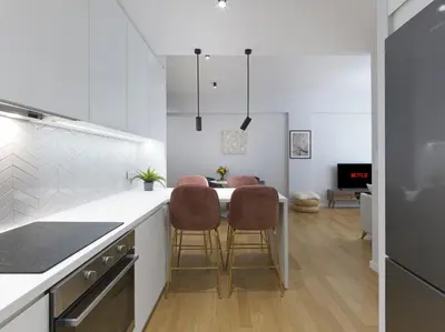 a kitchen with a table and chairs in a room at FRESH, NEW & READY FOR YOU! RNVTD APT IN KOUKAKI! in Athens