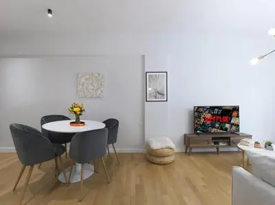 a white living room with a table and chairs at FRESH, NEW & READY FOR YOU! RNVTD APT IN KOUKAKI! in Athens