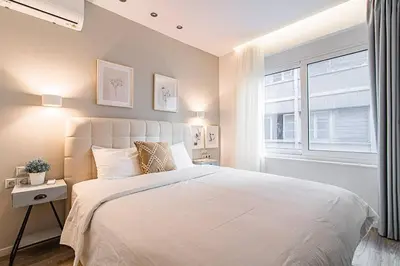 a bedroom with a white bed and a window at A12 Pristine 1bedrooom flat near Parthenon in Athens' heart in Athens