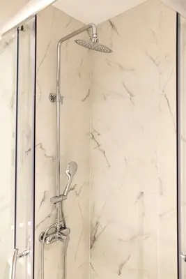 a shower in a bathroom with white marble at A12 Pristine 1bedrooom flat near Parthenon in Athens' heart in Athens