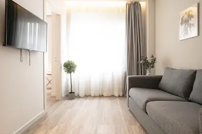 a living room with a couch and a window at A12 Pristine 1bedrooom flat near Parthenon in Athens' heart in Athens