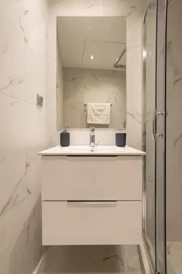a white bathroom with a sink and a shower at A12 Pristine 1bedrooom flat near Parthenon in Athens' heart in Athens