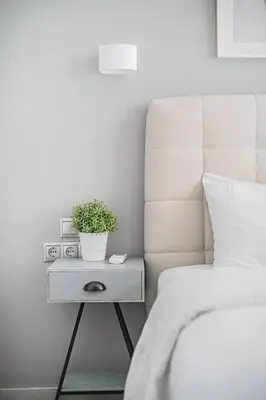 a bedroom with a bed and a table with a plant on it at A12 Pristine 1bedrooom flat near Parthenon in Athens' heart in Athens