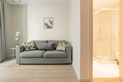 a living room with a gray couch in a room at A14 Sunny & chic 2Room apartment near Plaka & Parthenon in Athens