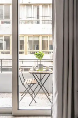 a table with a potted plant on a balcony at A14 Sunny & chic 2Room apartment near Plaka & Parthenon in Athens