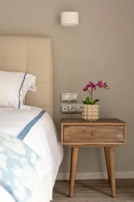 a table with a plant on it next to a bed at A14 Sunny & chic 2Room apartment near Plaka & Parthenon in Athens