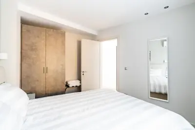 a white bedroom with a bed and a closet at A17 Modern & Cosy 2Room flat up to 4ppl near Parthenon, 1Bedroom 1livingroom in Athens