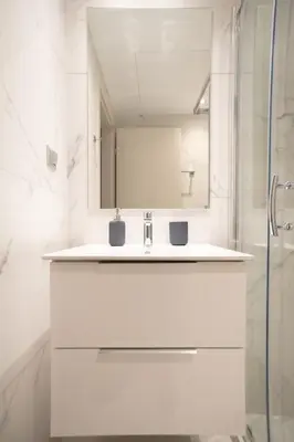 a white bathroom with a sink and a mirror at A17 Modern & Cosy 2Room flat up to 4ppl near Parthenon, 1Bedroom 1livingroom in Athens