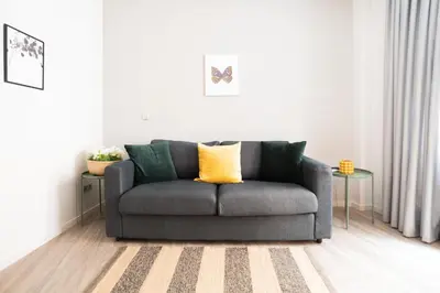 a living room with a gray couch and two tables at A17 Modern & Cosy 2Room flat up to 4ppl near Parthenon, 1Bedroom 1livingroom in Athens