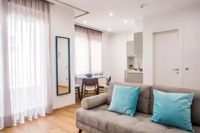 a living room with a couch and a table at A23 Premium suite with balcony near Parthenon in Athens