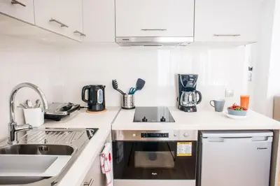 a kitchen with a sink and a stove top oven at A23 Premium suite with balcony near Parthenon in Athens