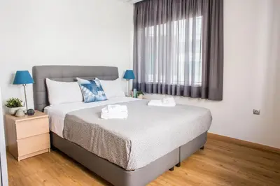 a bedroom with a large bed and a window at A23 Premium suite with balcony near Parthenon in Athens