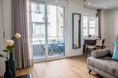 a living room with a couch and a table at A23 Premium suite with balcony near Parthenon in Athens