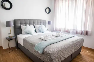 a bedroom with a bed with towels on it at A21 Premium Suite a breath away from Parthenon! in Athens