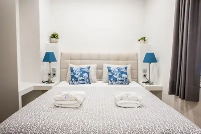 a bedroom with a bed with towels on it at A21 Premium Suite a breath away from Parthenon! in Athens
