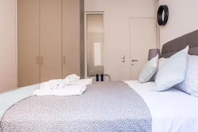 a bedroom with a white bed with towels on it at A21 Premium Suite a breath away from Parthenon! in Athens