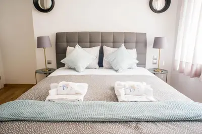a bedroom with a large bed with towels on it at A21 Premium Suite a breath away from Parthenon! in Athens