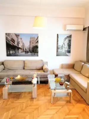 a living room with a couch and a table at Stunning Acropolis view apartment in Athens