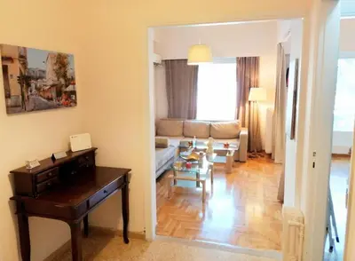 a living room with a table and a couch at Stunning Acropolis view apartment in Athens