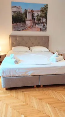a large bed in a bedroom with a painting on the wall at Stunning Acropolis view apartment in Athens