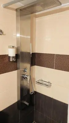 a bathroom with a shower with a glass door at Stunning Acropolis view apartment in Athens