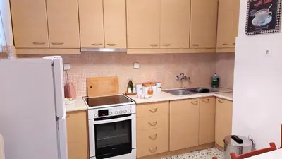 a small kitchen with a stove and a sink at Stunning Acropolis view apartment in Athens