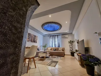 a living room with a couch and a table at Arman Group in Athens