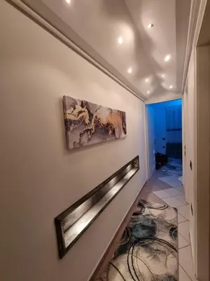 a staircase in a house with a painting on the wall at Arman Group in Athens