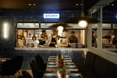 a group of chefs preparing food in a restaurant at The Port Square Hotel in Piraeus