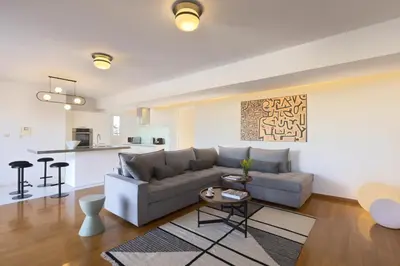 a living room with a couch and a table at NEW STUNNING PENTHOUSE W/SPECTACULAR VISTAS! in Athens