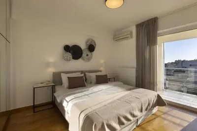 a bedroom with a large bed and a large window at NEW STUNNING PENTHOUSE W/SPECTACULAR VISTAS! in Athens