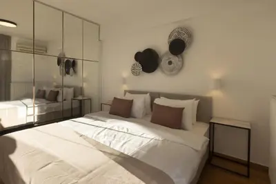 a bedroom with a large white bed and a mirror at NEW STUNNING PENTHOUSE W/SPECTACULAR VISTAS! in Athens