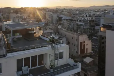 an aerial view of a city at sunset at NEW STUNNING PENTHOUSE W/SPECTACULAR VISTAS! in Athens