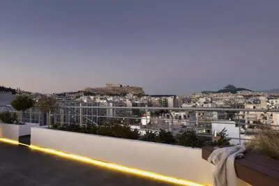 a view of a city at night from a balcony at NEW STUNNING PENTHOUSE W/SPECTACULAR VISTAS! in Athens
