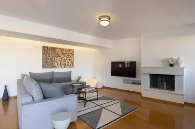 a living room with a couch and a fireplace at NEW STUNNING PENTHOUSE W/SPECTACULAR VISTAS! in Athens