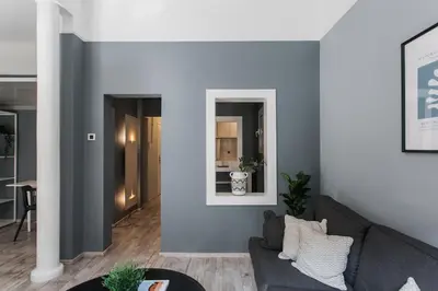 a living room with a couch and a mirror at Unique 2BR Apartment in Filothei by UPSTREET in Athens