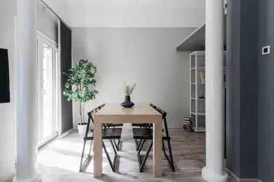 a dining room with a wooden table and chairs at Unique 2BR Apartment in Filothei by UPSTREET in Athens