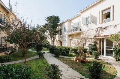 a courtyard of an apartment building with trees and bushes at Unique 2BR Apartment in Filothei by UPSTREET in Athens