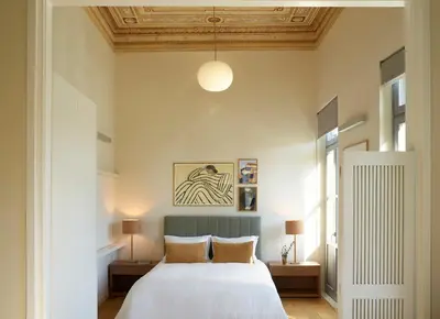a bedroom with a white bed and a ceiling at Del Taso 1850 in Athens