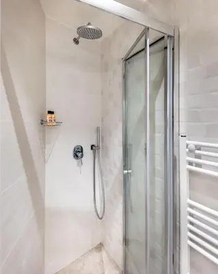 a shower with a glass door in a bathroom at J&A Luxury Residence in Athens