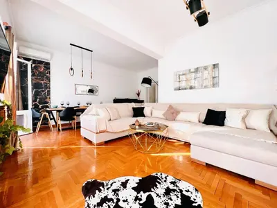 a living room with a white couch and a table at Seaside apartment in Flisvos marina in Athens