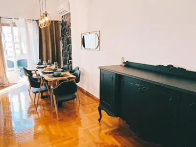 a dining room with a table and chairs at Seaside apartment in Flisvos marina in Athens