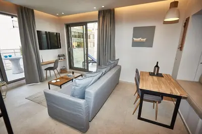 a living room with a couch and a table at THE VAULT Brand New Loft in Athens Historic Center in Athens