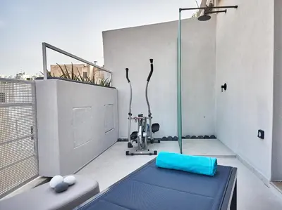 a room with a exercise machine on a balcony at THE VAULT Brand New Loft in Athens Historic Center in Athens