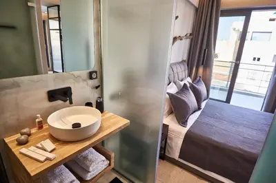 a bathroom with a sink and a bed at THE VAULT Brand New Loft in Athens Historic Center in Athens