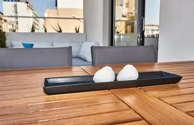 a plate on a wooden table with a pair of shoes at THE VAULT Brand New Loft in Athens Historic Center in Athens